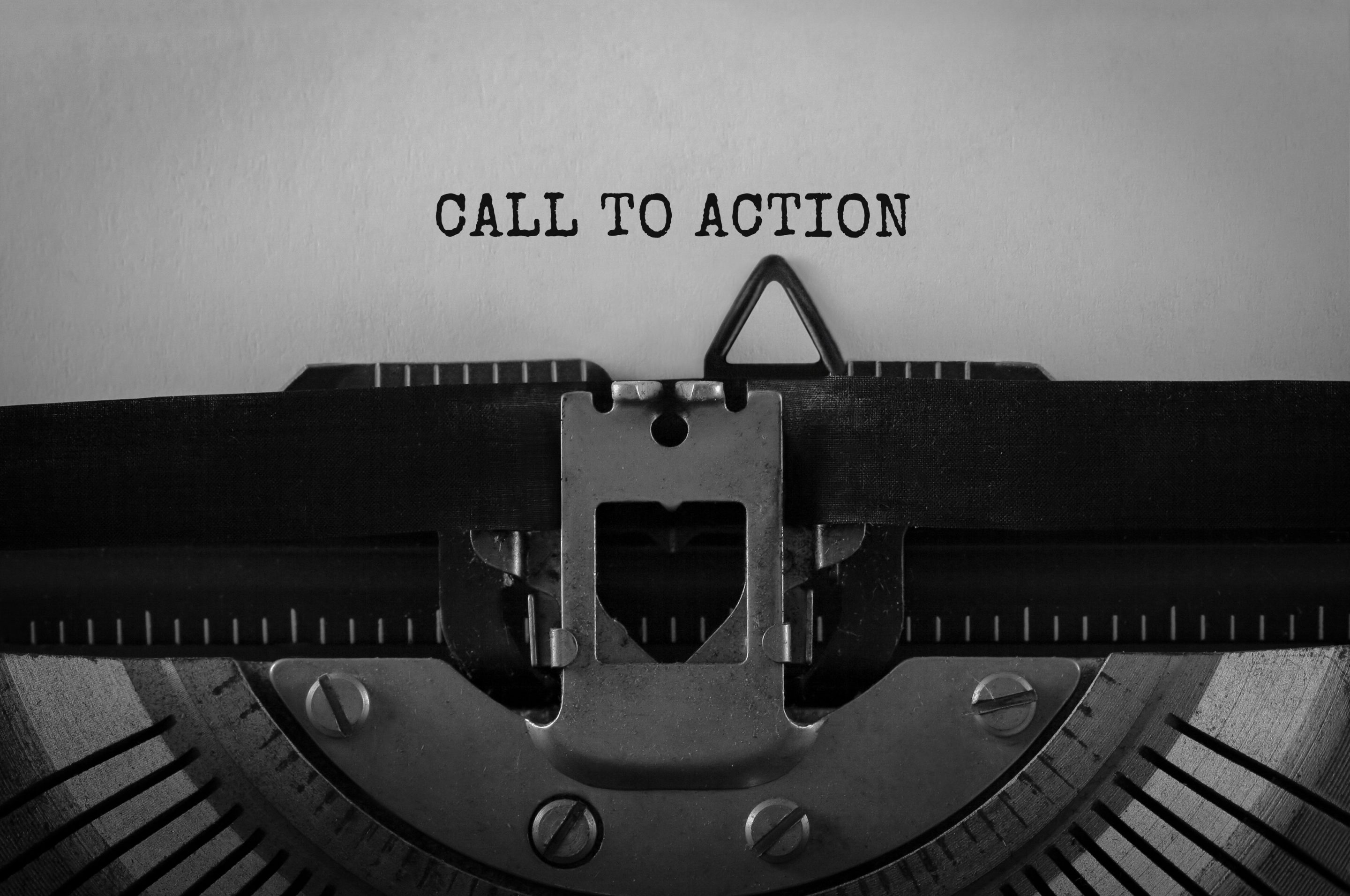 A typewriter with the word "call to action" written on it, ready to create a compelling call to action for your website.
