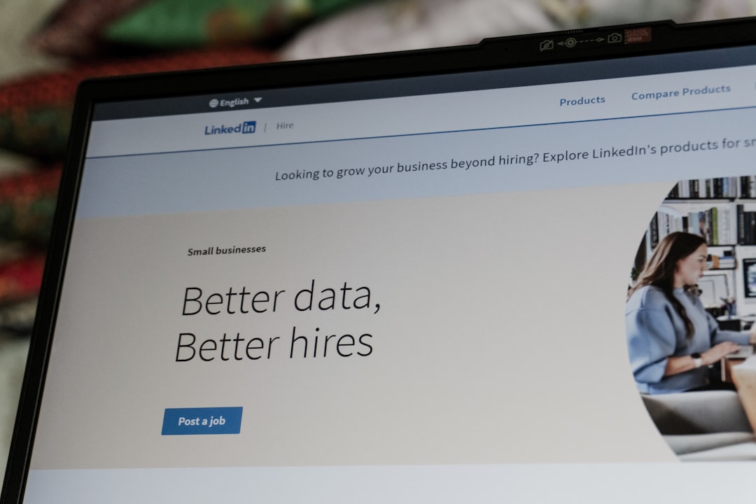 A computer screen displays a LinkedIn webpage for small businesses with the headline "Better data, Better hires" and a blue "Post a job" button. On the right, a blurred image of a person working at their desk hints at local SEO success for any small business website.